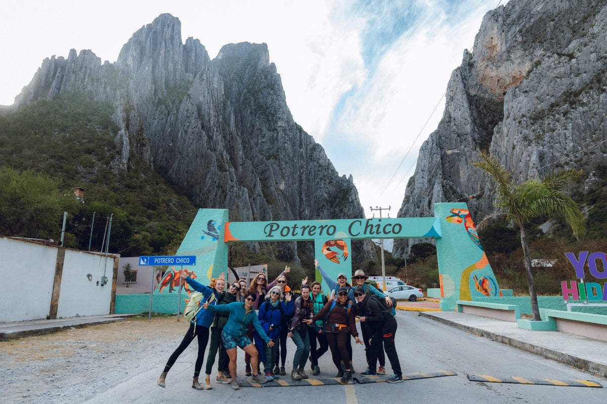 She Moves Mountains guests smiling together at the entrance to El Potrero Chico